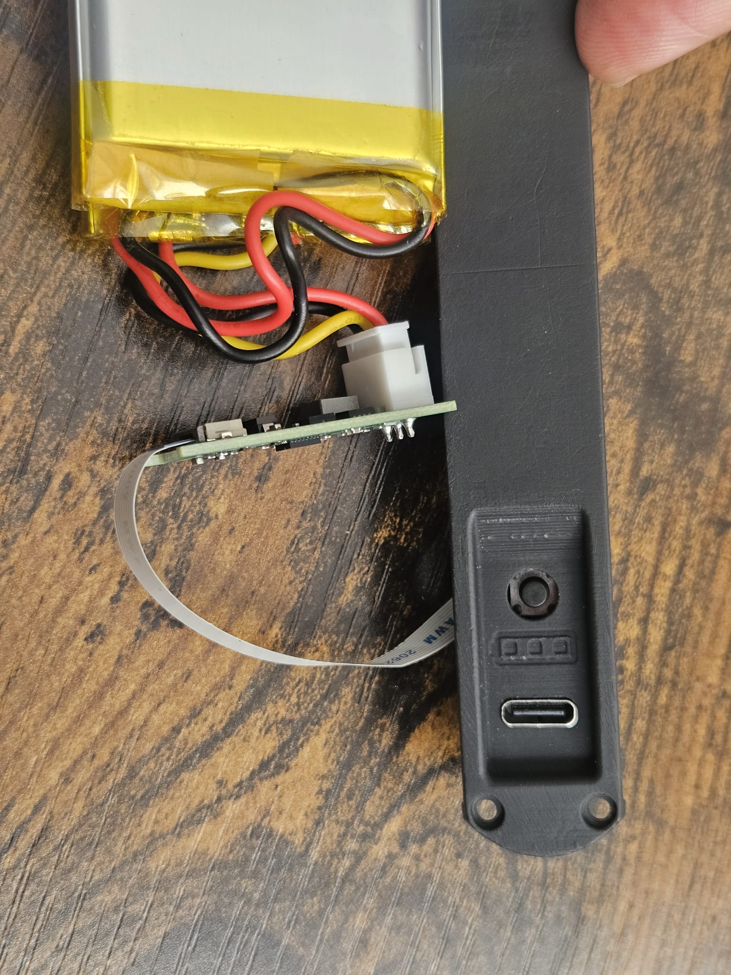 The end cap carrying the USB-C port, button and charge-status LEDs, with the pack alongside